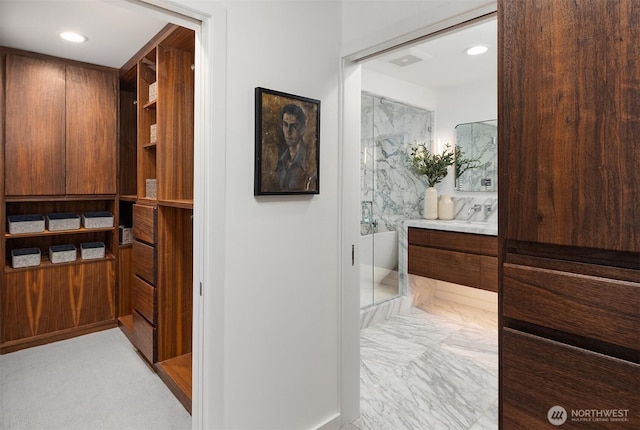 hall featuring recessed lighting, marble finish floor, and visible vents