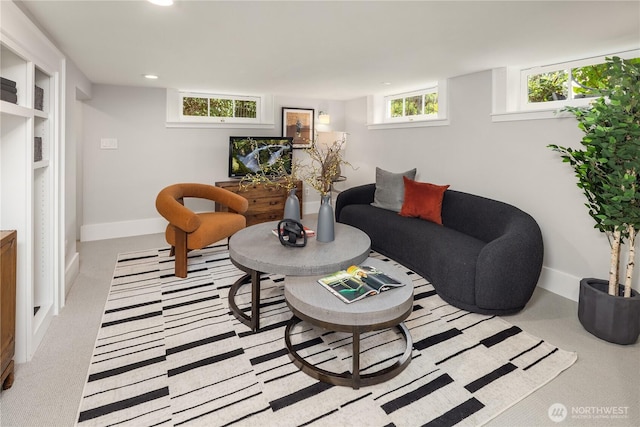 living area featuring recessed lighting, baseboards, and light carpet