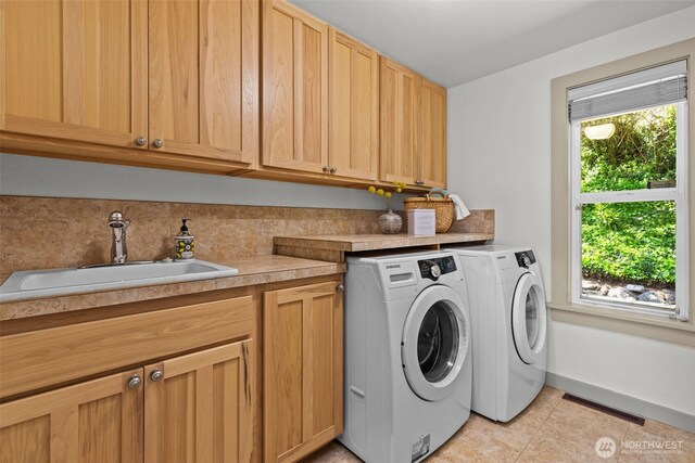 2716 58th Street Ct NW, Gig Harbor, WA 98335 - laundry room with a sink, cabinet space, light tile patterned flooring, visible vents, and separate washer and dryer