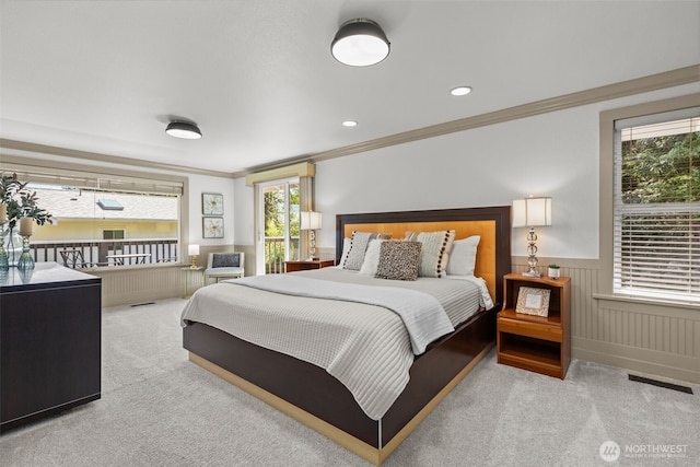 2716 58th Street Ct NW, Gig Harbor, WA 98335 - carpeted bedroom featuring multiple windows, visible vents, crown molding, and a wainscoted wall