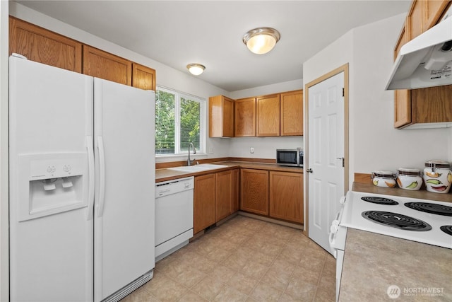 926 99th St SW, Everett, WA 98204 - kitchen with white appliances, a sink, under cabinet range hood, and brown cabinets