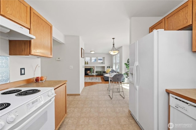 926 99th St SW, Everett, WA 98204 - kitchen featuring white appliances, under cabinet range hood, light flooring, open floor plan, and light countertops