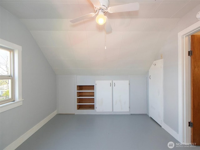 additional living space with a ceiling fan, baseboards, and lofted ceiling