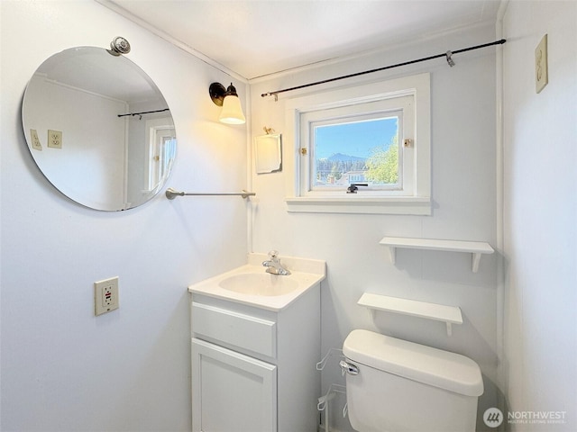 bathroom featuring vanity and toilet