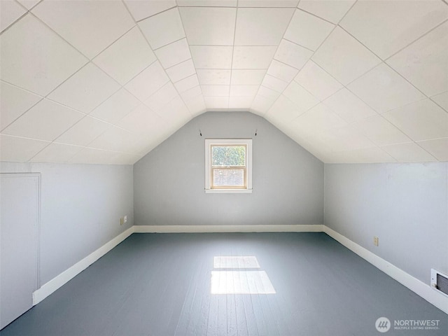 bonus room with baseboards and lofted ceiling