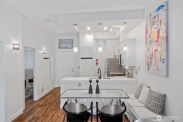 521 7th Ave Unit 204, Kirkland, WA 98033 - kitchen featuring stainless steel appliances, a sink, light countertops, dark wood-style floors, and white cabinets
