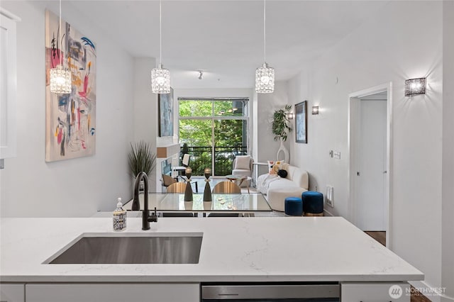521 7th Ave Unit 204, Kirkland, WA 98033 - kitchen with a sink, stainless steel dishwasher, open floor plan, and light stone countertops