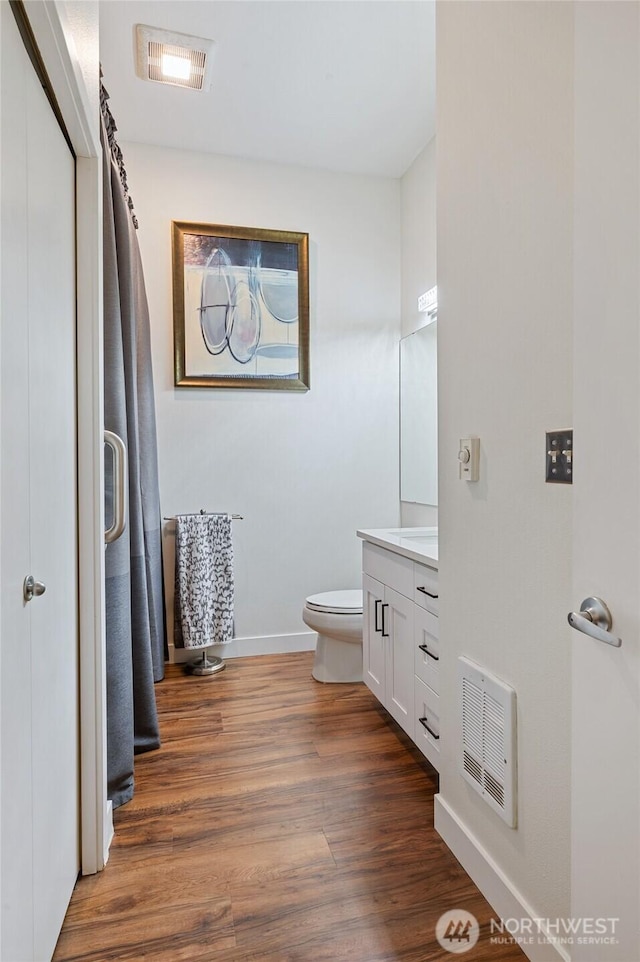 521 7th Ave Unit 204, Kirkland, WA 98033 - bathroom featuring toilet, wood finished floors, baseboards, and vanity