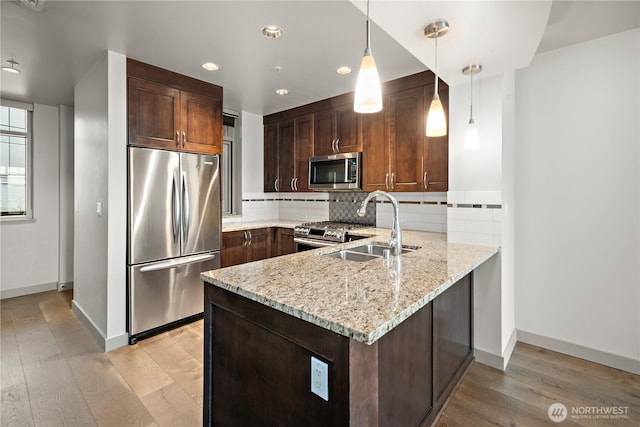10610 NE 9th Pl Unit G403, Bellevue, WA 98004 - kitchen featuring stainless steel appliances, a peninsula, recessed lighting, light wood-style floors, and a sink