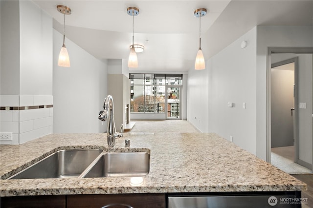 10610 NE 9th Pl Unit G403, Bellevue, WA 98004 - kitchen featuring a sink, light stone countertops, and decorative light fixtures