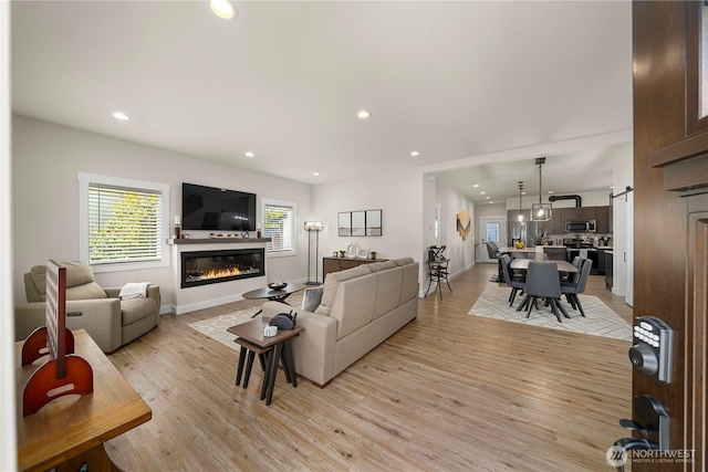 3315 N 35th St, Tacoma, WA 98407 - living room with recessed lighting, baseboards, a glass covered fireplace, and light wood-style floors
