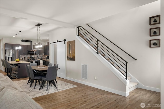 3315 N 35th St, Tacoma, WA 98407 - dining area with baseboards, visible vents, light wood finished floors, and stairway