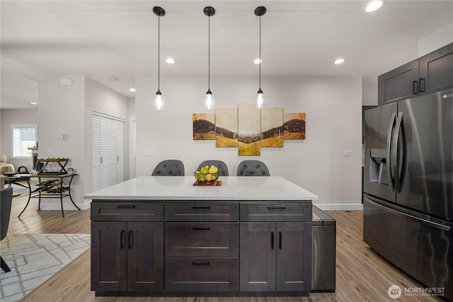 3315 N 35th St, Tacoma, WA 98407 - kitchen featuring light countertops, stainless steel refrigerator with ice dispenser, hanging light fixtures, and wood finished floors