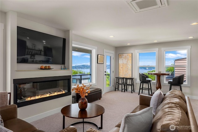 3315 N 35th St, Tacoma, WA 98407 - living area featuring carpet flooring, a glass covered fireplace, baseboards, a water view, and visible vents