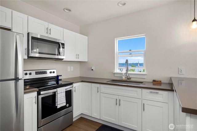 3315 N 35th St, Tacoma, WA 98407 - kitchen with stainless steel appliances, dark countertops, and a sink