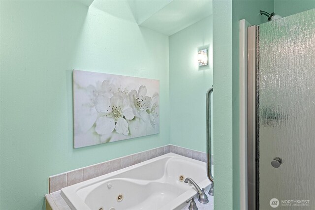 full bathroom featuring a stall shower and a jetted tub