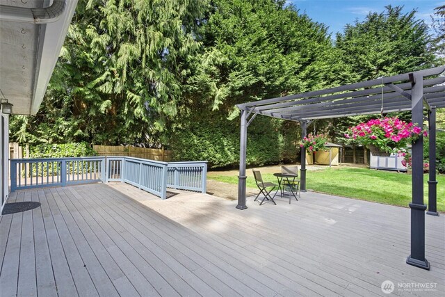 wooden terrace with a lawn, a fenced backyard, and a pergola