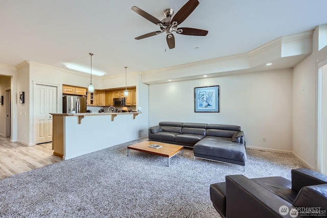 320 E 32nd St Unit 105, Tacoma, WA 98404 - living area with baseboards, light colored carpet, ceiling fan, and crown molding