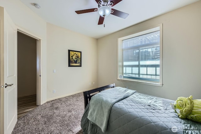 320 E 32nd St Unit 105, Tacoma, WA 98404 - bedroom with baseboards, a ceiling fan, and carpet flooring