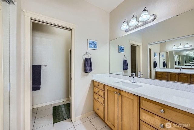 320 E 32nd St Unit 105, Tacoma, WA 98404 - full bath with tile patterned floors, vanity, and baseboards