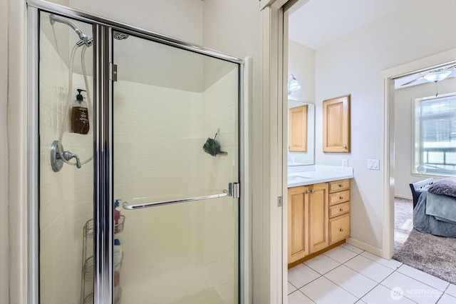 320 E 32nd St Unit 105, Tacoma, WA 98404 - bathroom with ensuite bathroom, a stall shower, baseboards, vanity, and tile patterned flooring