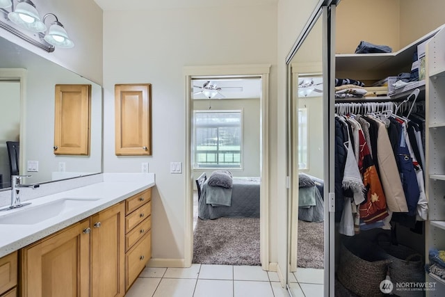 320 E 32nd St Unit 105, Tacoma, WA 98404 - ensuite bathroom with ensuite bath, tile patterned flooring, ceiling fan, vanity, and a walk in closet