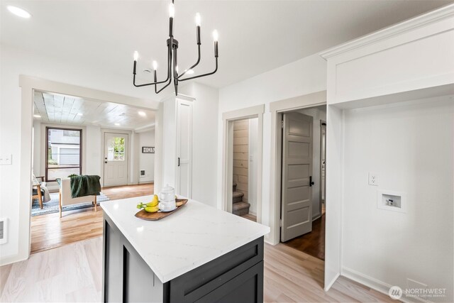 1538 7th St, Bremerton, WA 98337 - kitchen with light wood-style floors, light stone counters, pendant lighting, and a center island