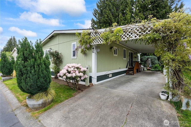 607 37th St SE Unit 92, Auburn, WA 98002 - view of side of home with driveway, a carport, entry steps, and crawl space