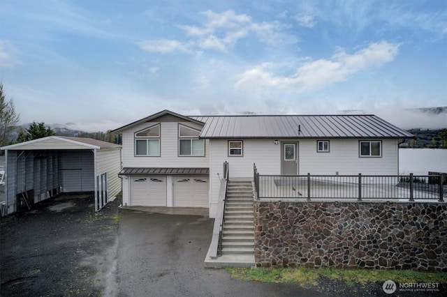 277 W Sunny Sands Rd, Cathlamet, WA 98612 - view of front of house with a carport, stairs, a standing seam roof, metal roof, and a garage
