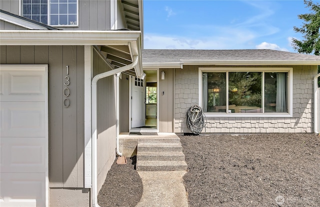 1300 Rhododendron Ct NE, Olympia, WA 98516 - property entrance with a garage and a shingled roof