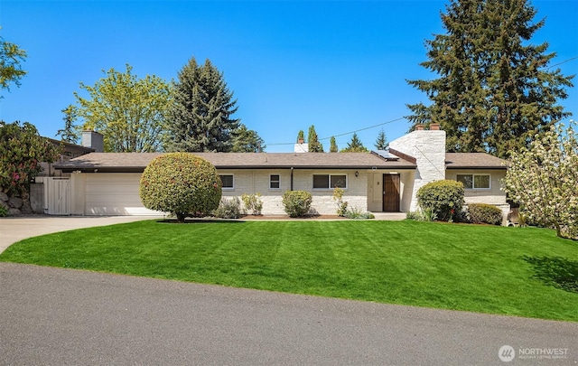 9750 SE 41st St, Mercer Island, WA 98040 - single story home with concrete driveway, brick siding, an attached garage, and a front lawn
