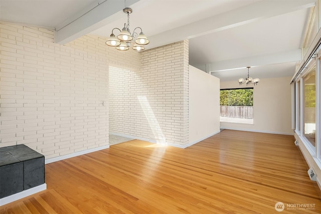 9750 SE 41st St, Mercer Island, WA 98040 - unfurnished dining area featuring an inviting chandelier, brick wall, baseboards, lofted ceiling with beams, and light wood-style flooring