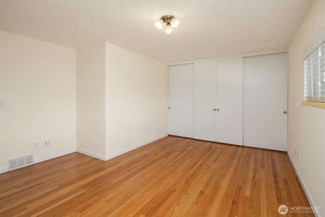 9750 SE 41st St, Mercer Island, WA 98040 - unfurnished bedroom with baseboards, visible vents, light wood-style flooring, and a closet