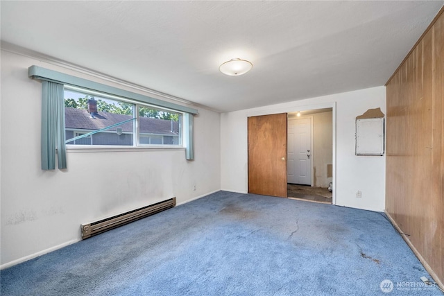 unfurnished bedroom featuring carpet floors, baseboards, and baseboard heating