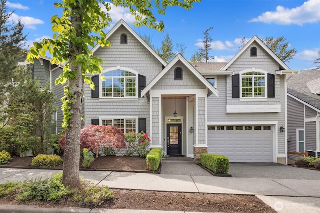 raised ranch with driveway and an attached garage