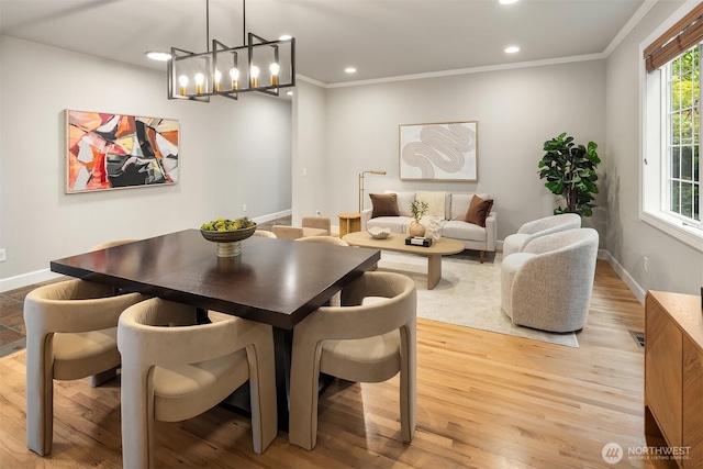 dining area with baseboards, crown molding, light wood finished floors, recessed lighting, and a chandelier