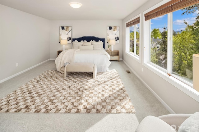 carpeted bedroom with baseboards