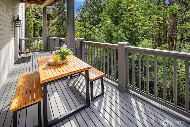 wooden deck featuring outdoor dining space