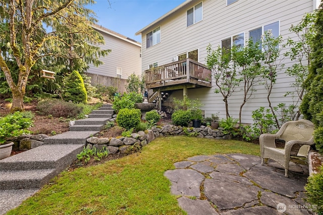 view of yard featuring a patio, a wooden deck, and stairs