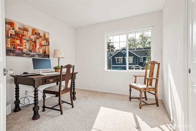 carpeted home office featuring baseboards