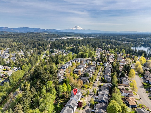 aerial view with a residential view, a wooded view, and a mountain view