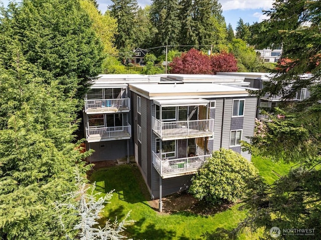 back of property featuring a balcony
