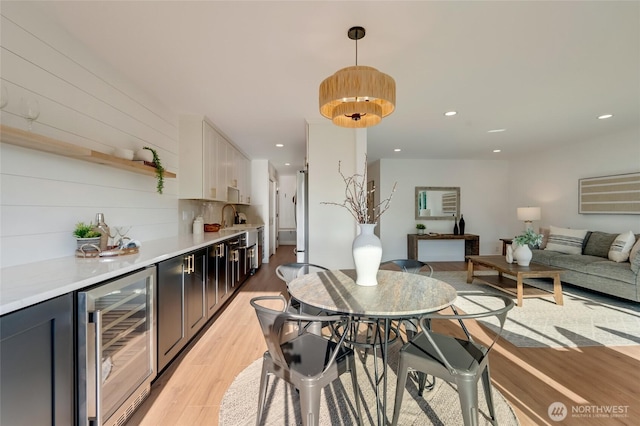 321 Bellevue Way SE Unit 401, Bellevue, WA 98004 - dining space featuring beverage cooler, recessed lighting, and light wood-style flooring