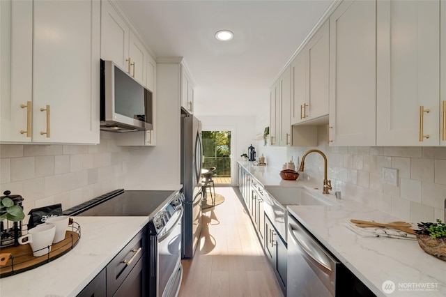 321 Bellevue Way SE Unit 401, Bellevue, WA 98004 - kitchen featuring a sink, light stone counters, stainless steel appliances, and decorative backsplash