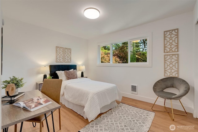 321 Bellevue Way SE Unit 401, Bellevue, WA 98004 - bedroom with visible vents, light wood finished floors, and baseboards