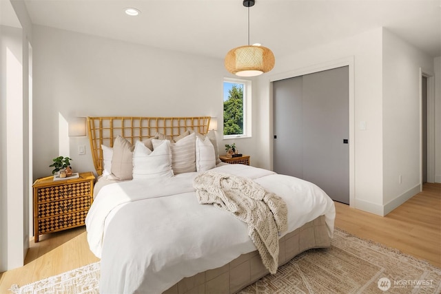 3650 51st Ave SW Unit B, Seattle, WA 98116 - bedroom with light wood-style flooring, baseboards, a closet, and recessed lighting