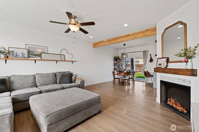 living room with recessed lighting, light wood-style flooring, ceiling fan, and beam ceiling