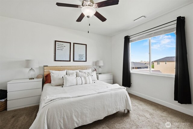 carpeted bedroom featuring baseboards, ceiling fan, and visible vents