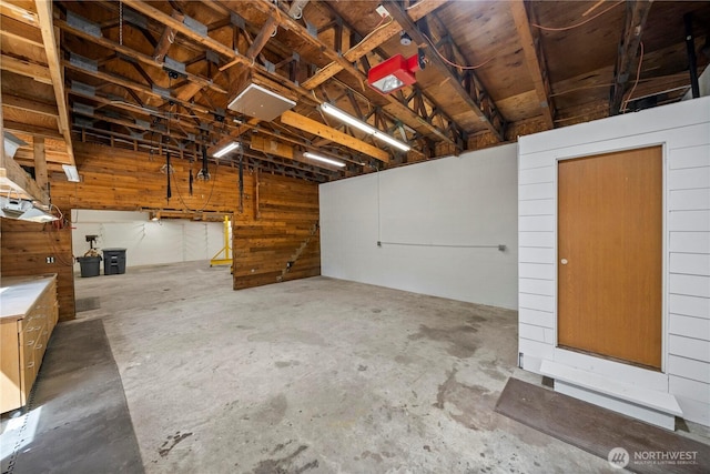 garage featuring wood walls