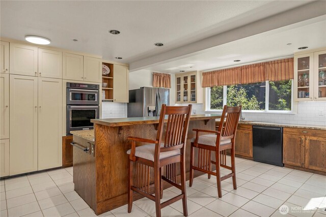kitchen with dishwasher, stainless steel fridge with ice dispenser, tasteful backsplash, and double oven
